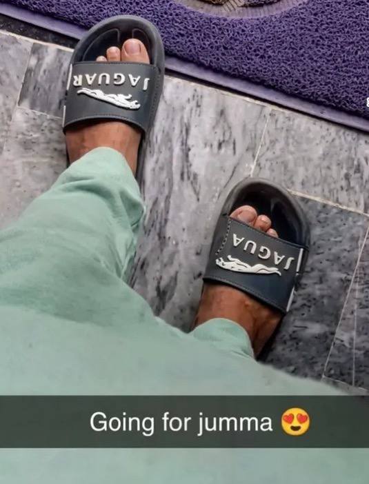 a person wearing black sandals and green pants